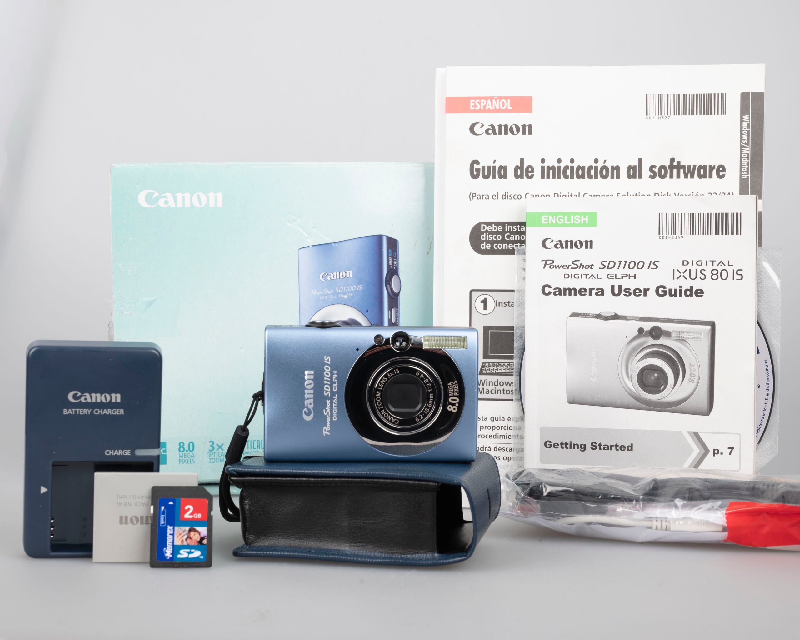 Canon PowerShot SD1000 Digital Elph Camera With factory Charger Battery Cords Manual